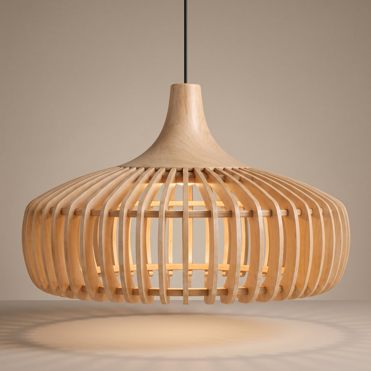 Handcrafted curved wood slat pendant lamp shade lit with a warm glow on a beige studio background