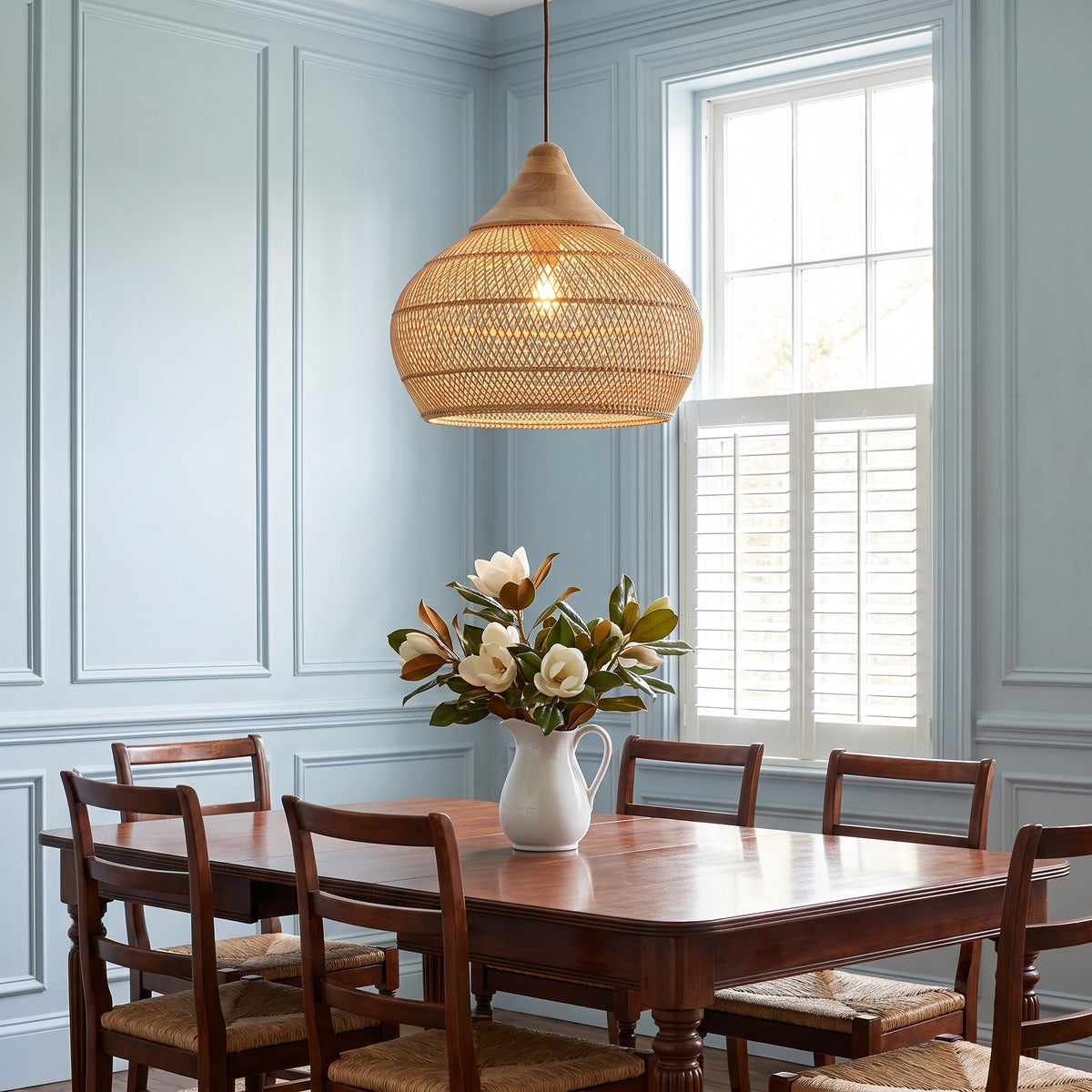 Wicker gourd pendant lamp shade with wood crown above a Charleston dining table