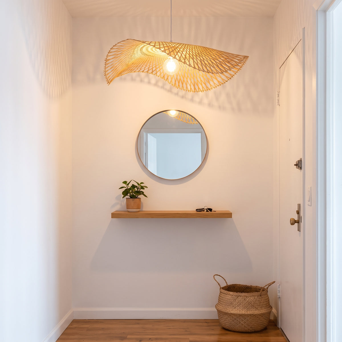 Bamboo cone pendant lamp shade in a Brooklyn apartment entryway