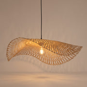 Handwoven bamboo cone pendant lamp shade lit with a warm glow on a beige studio background