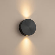 Duo Beam matte black up-down LED wall light, lit, studio view