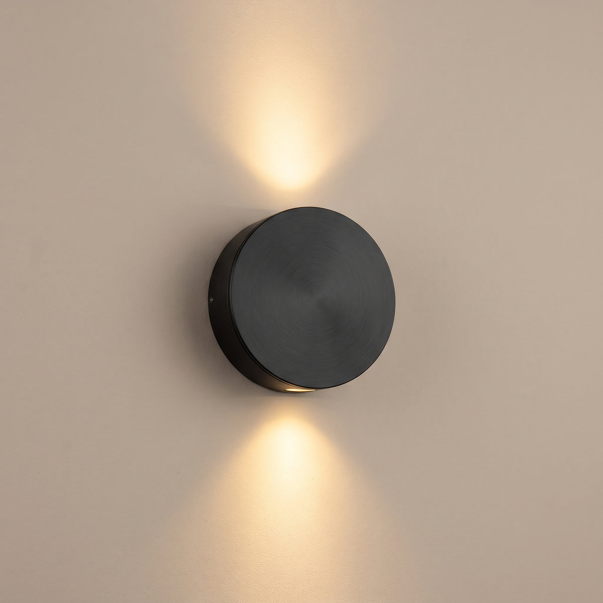 Duo Beam matte black up-down LED wall light, lit, studio view