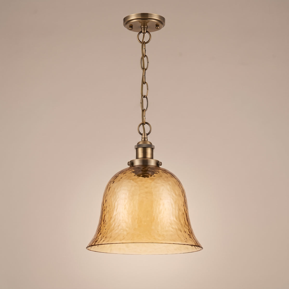 Ambra amber glass pendant, three-quarter view, unlit