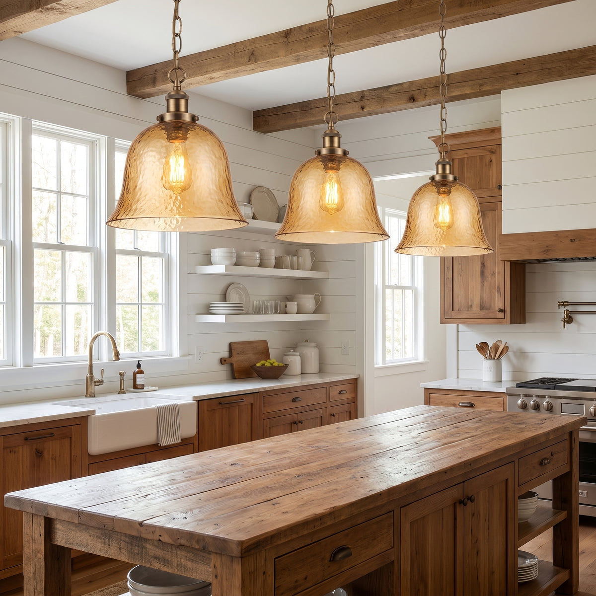 Three Ambra pendants above a farmhouse kitchen island