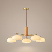 Kaki persimmon glass chandelier with wood and brass, lit, studio view