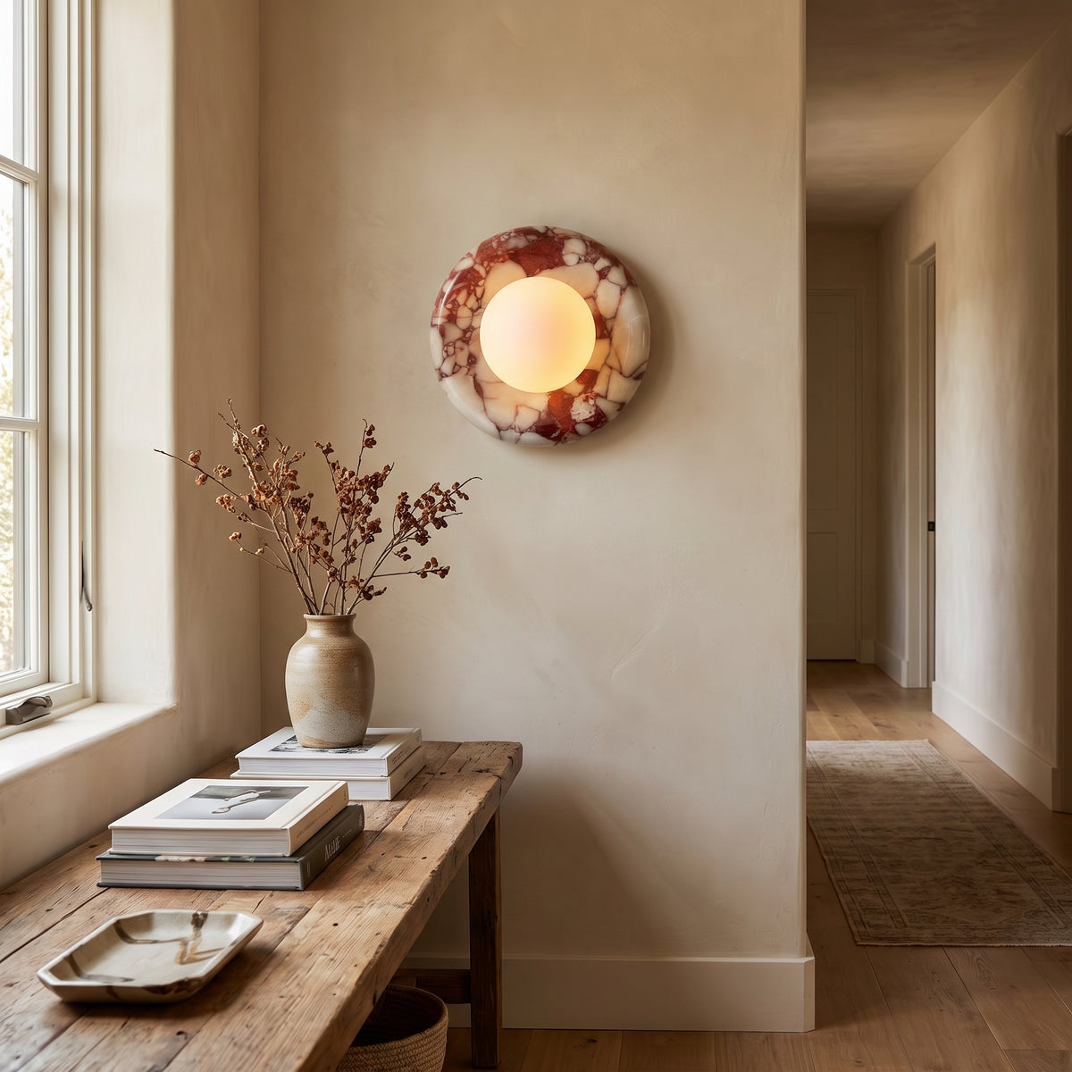 Rosso marble sconce in a chic hallway