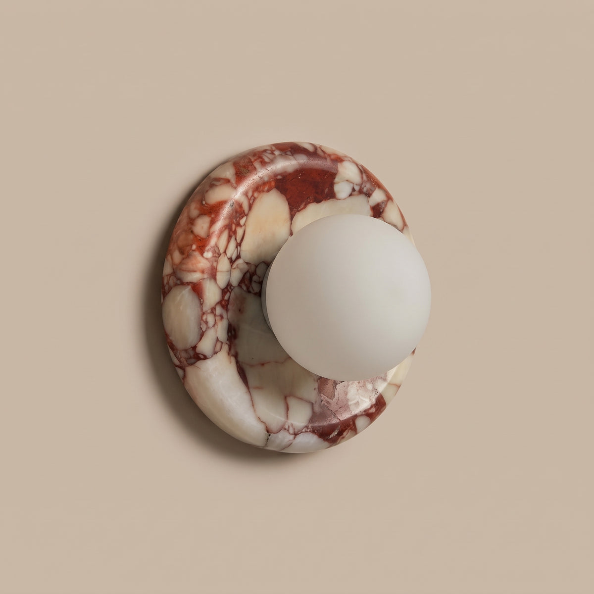 Rosso red marble globe sconce, three-quarter view, unlit