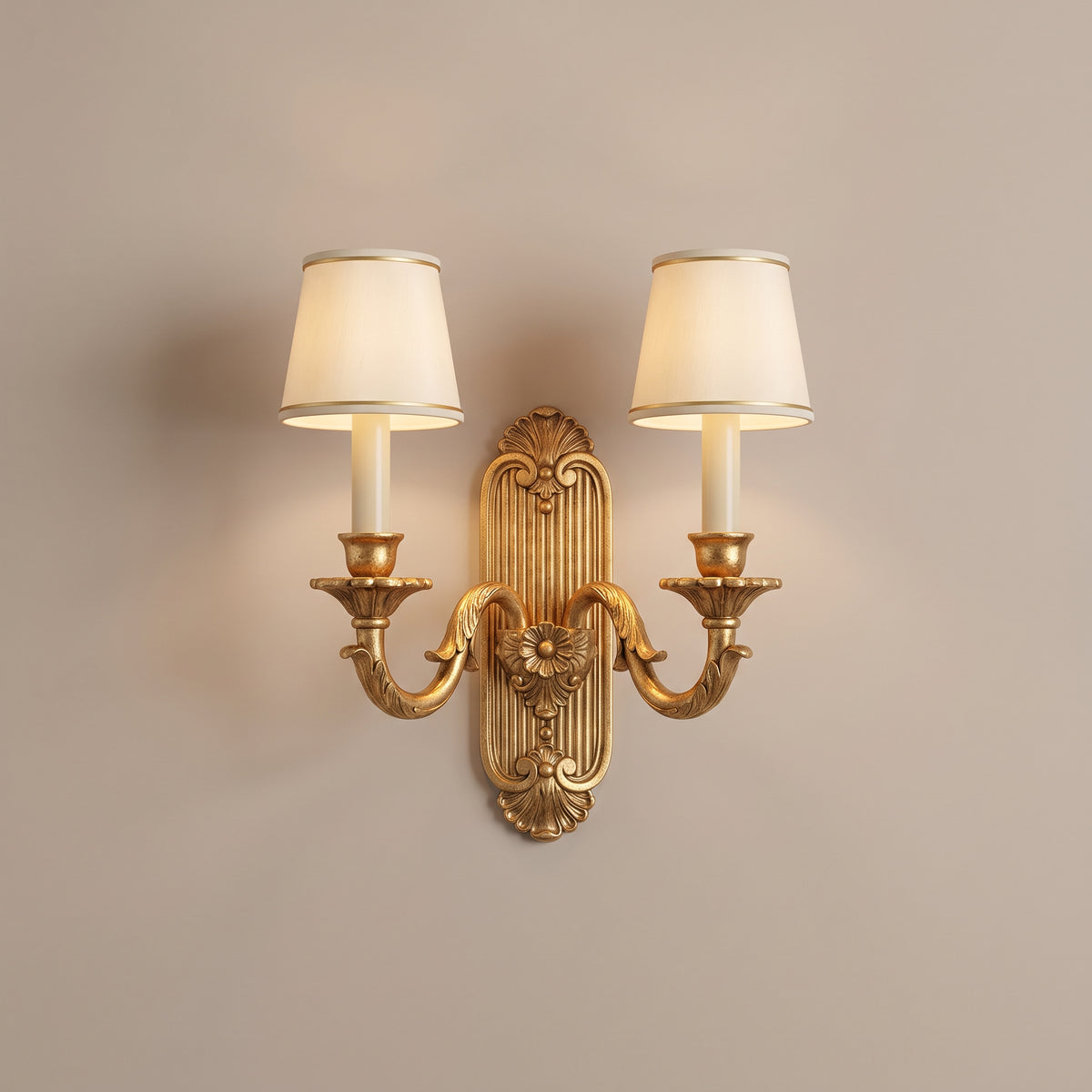Versailles antique gold leaf double candle wall sconce, lit, studio view
