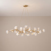 Ginkgo gold branch chandelier with white porcelain leaves, lit, studio view
