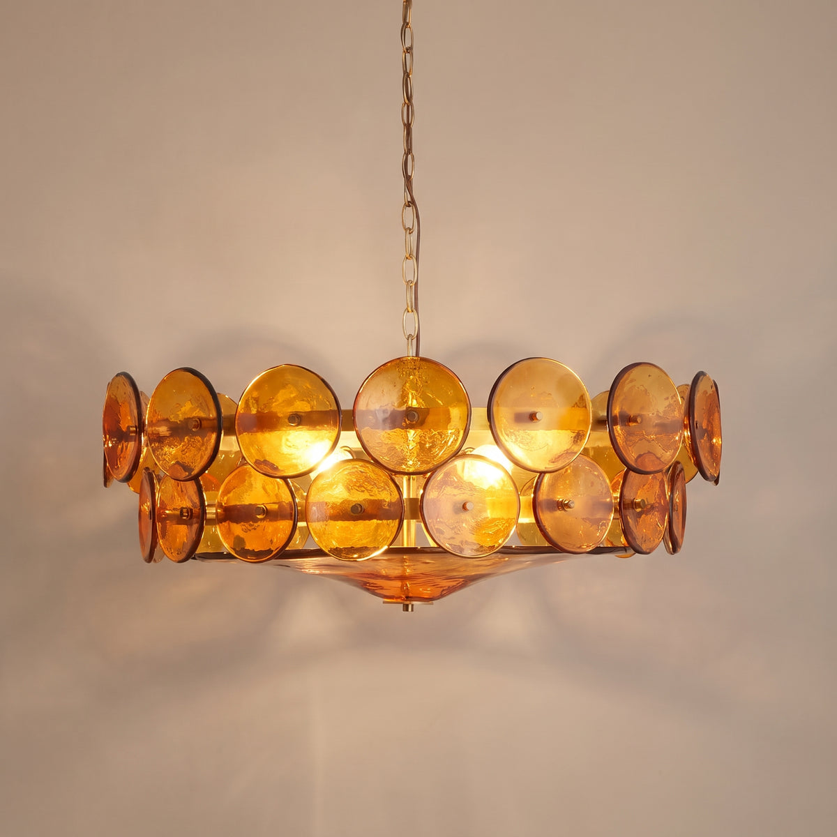 Solstice colored glass disc chandelier - studio photo, light on