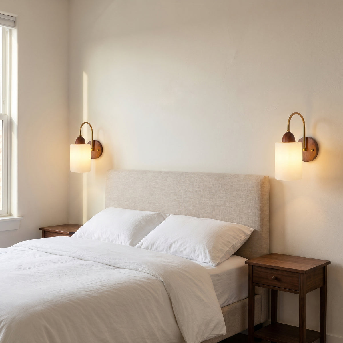 Walnut sconces by a bed, warm light