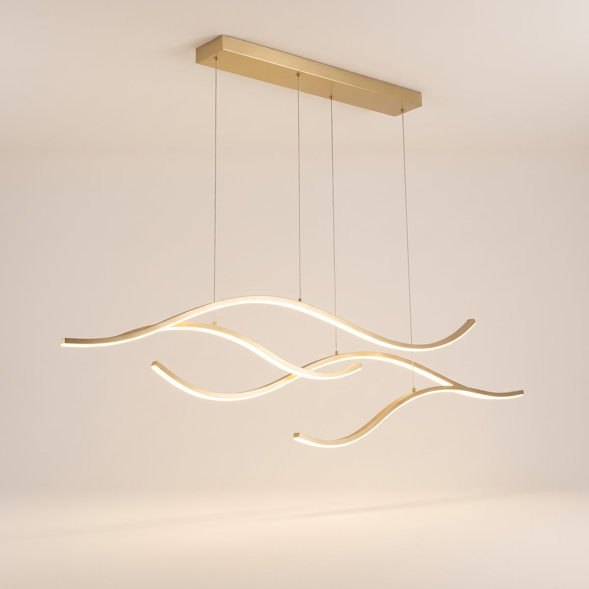 Soffio linear LED wave pendant light in gold, studio view