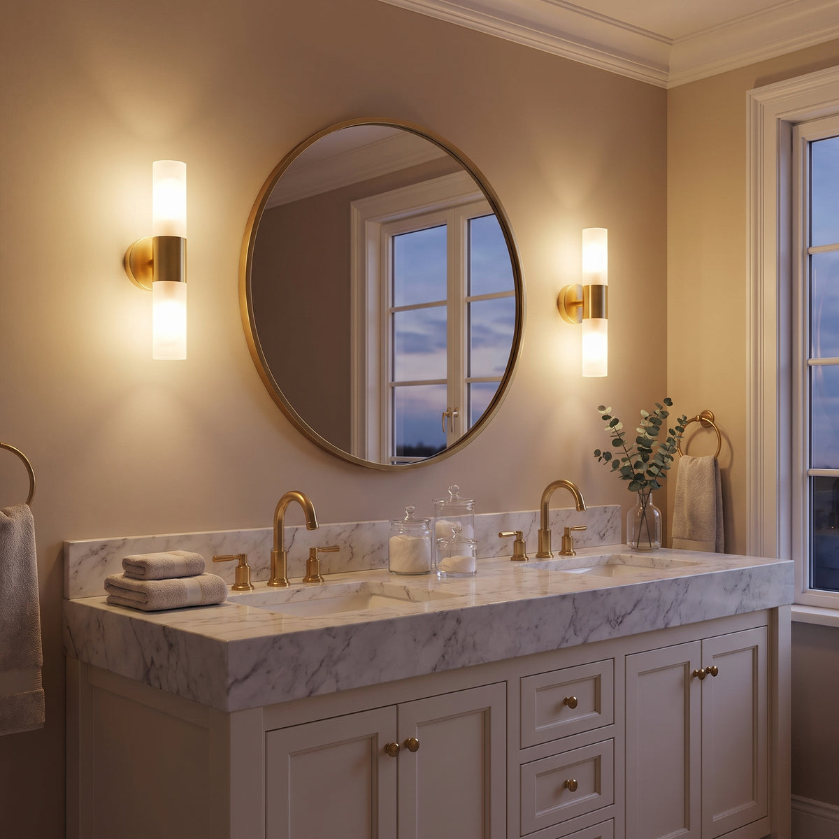 Tubo gold tube sconces flanking a bathroom mirror