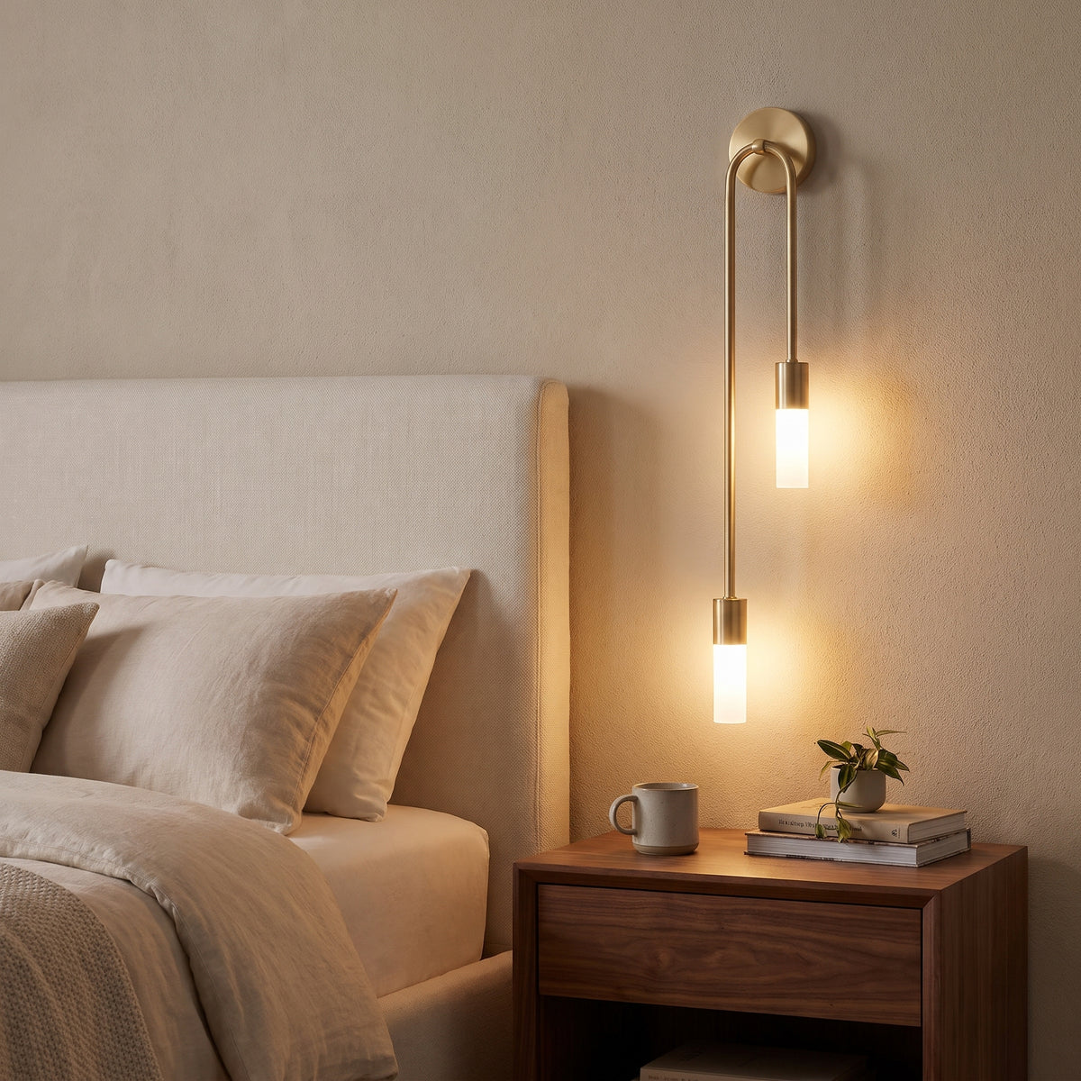 Ailes gold wall sconce beside a bed