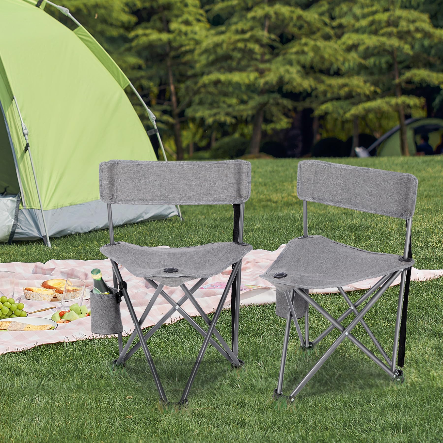 Two gray Alpine Retreat lightweight camping chairs with cup holders set up on a green lawn with a picnic blanket and a green tent in the background.