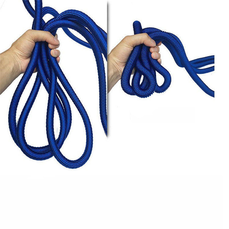 Two hands demonstrating the flexibility and compact storage of the AquaFlex high pressure garden hose, showing it loosely held and tightly coiled.