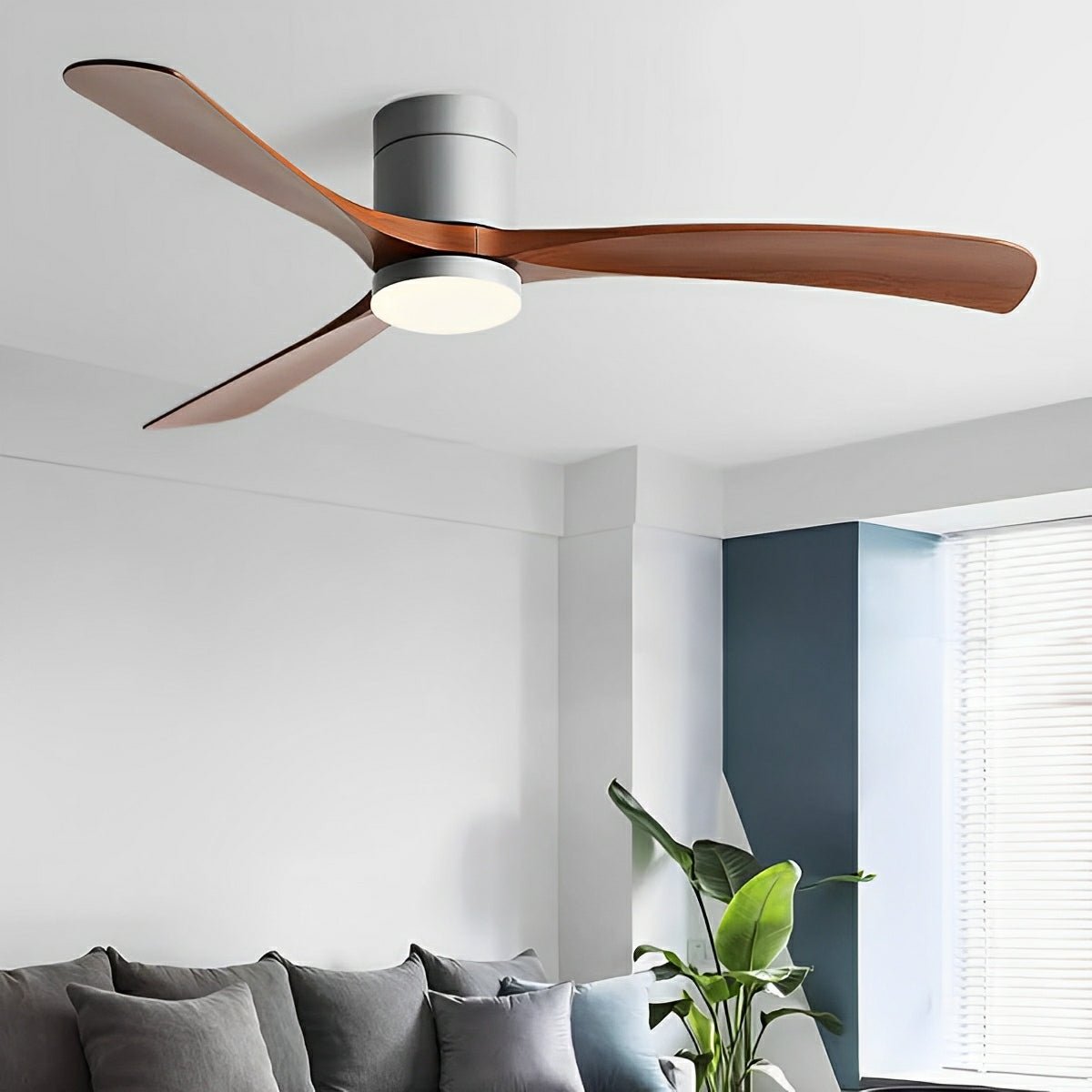 Arden Modern 6-Speed Reverse DC Ceiling Fan with copper-toned wood finish blades and a grey body, featuring an integrated PMMA light, installed in a contemporary living room above a grey sofa.