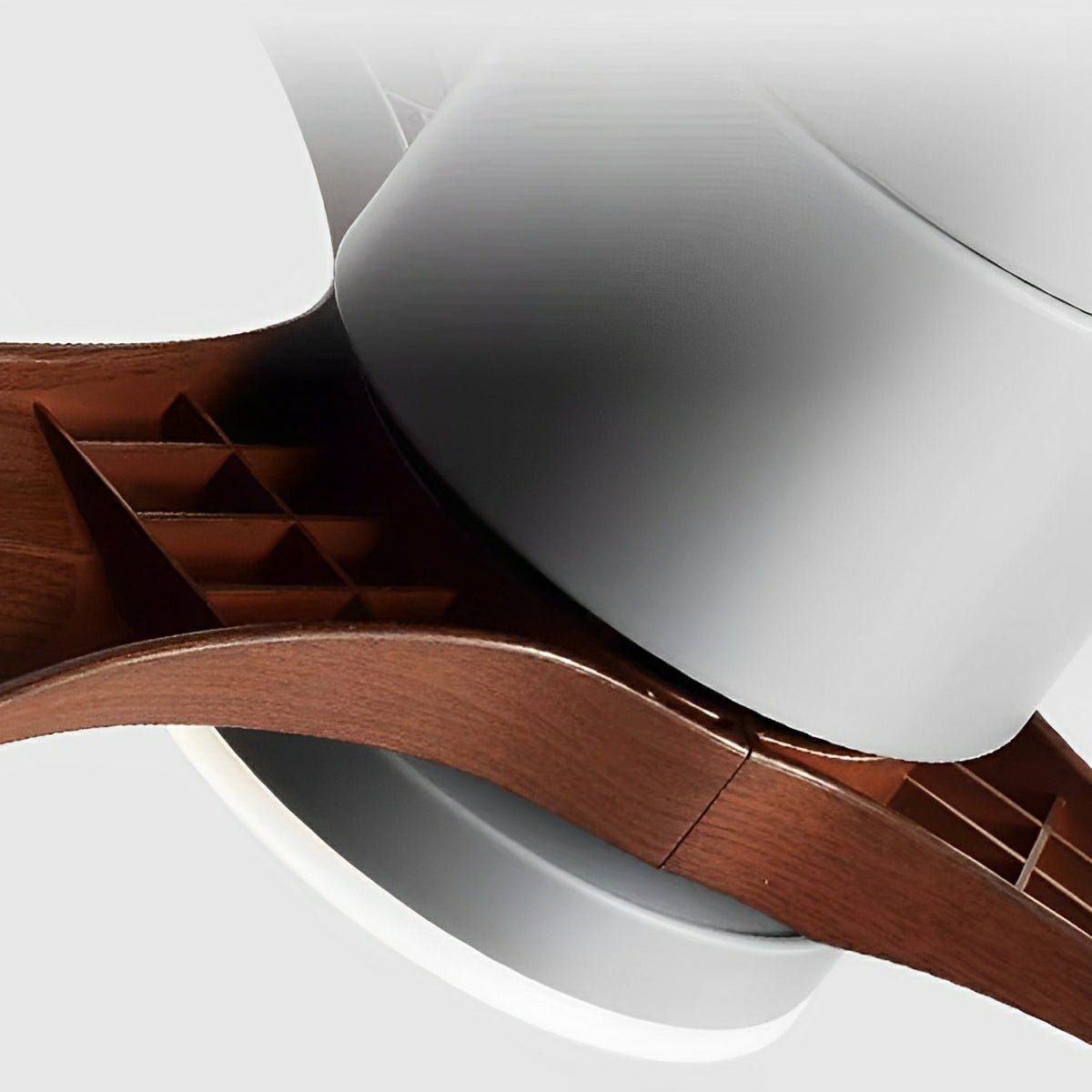 Close-up view Arden Modern 6-Speed Reverse DC Ceiling Fan, highlighting connection between a dark wood tone blade a white central housing. Shows quality finish PMMA light fixture.