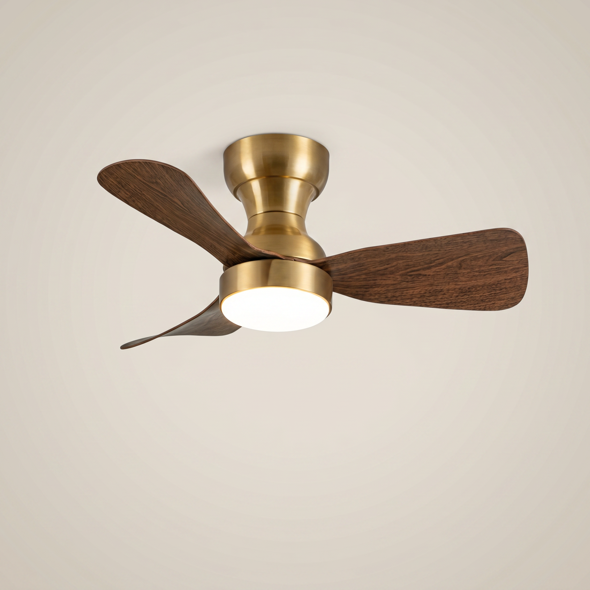 Brass ABS flush mount ceiling light with fan at three-quarter angle with dark wood blades lit