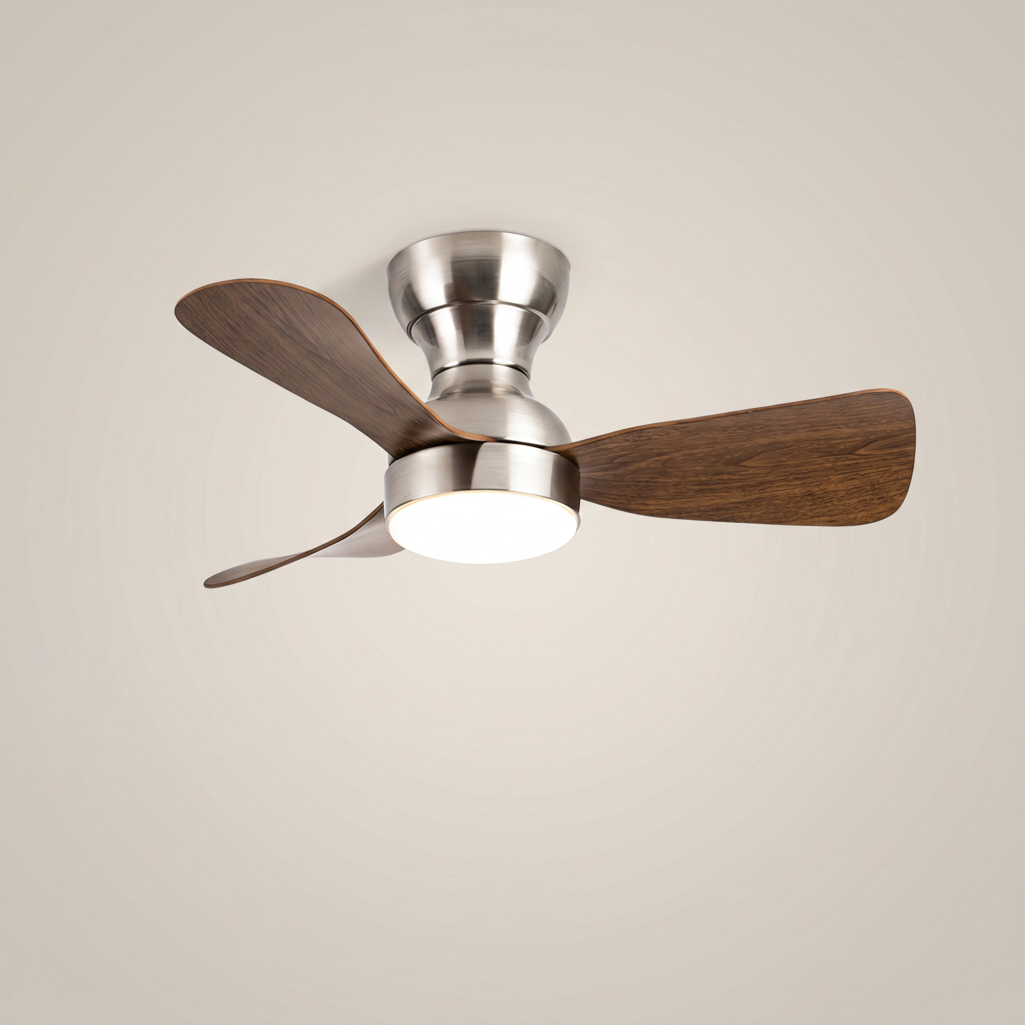 Silver ABS flush mount ceiling light with fan at three-quarter angle with dark wood blades lit