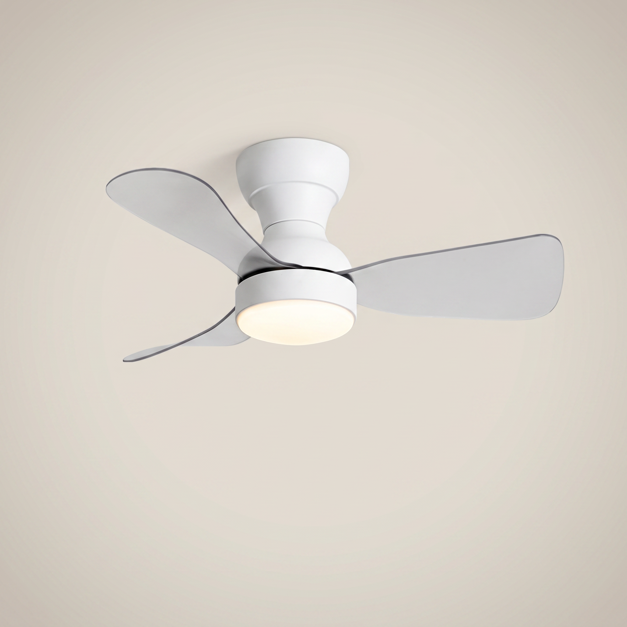 White ABS flush mount ceiling light with fan at three-quarter angle with clear ABS blades lit