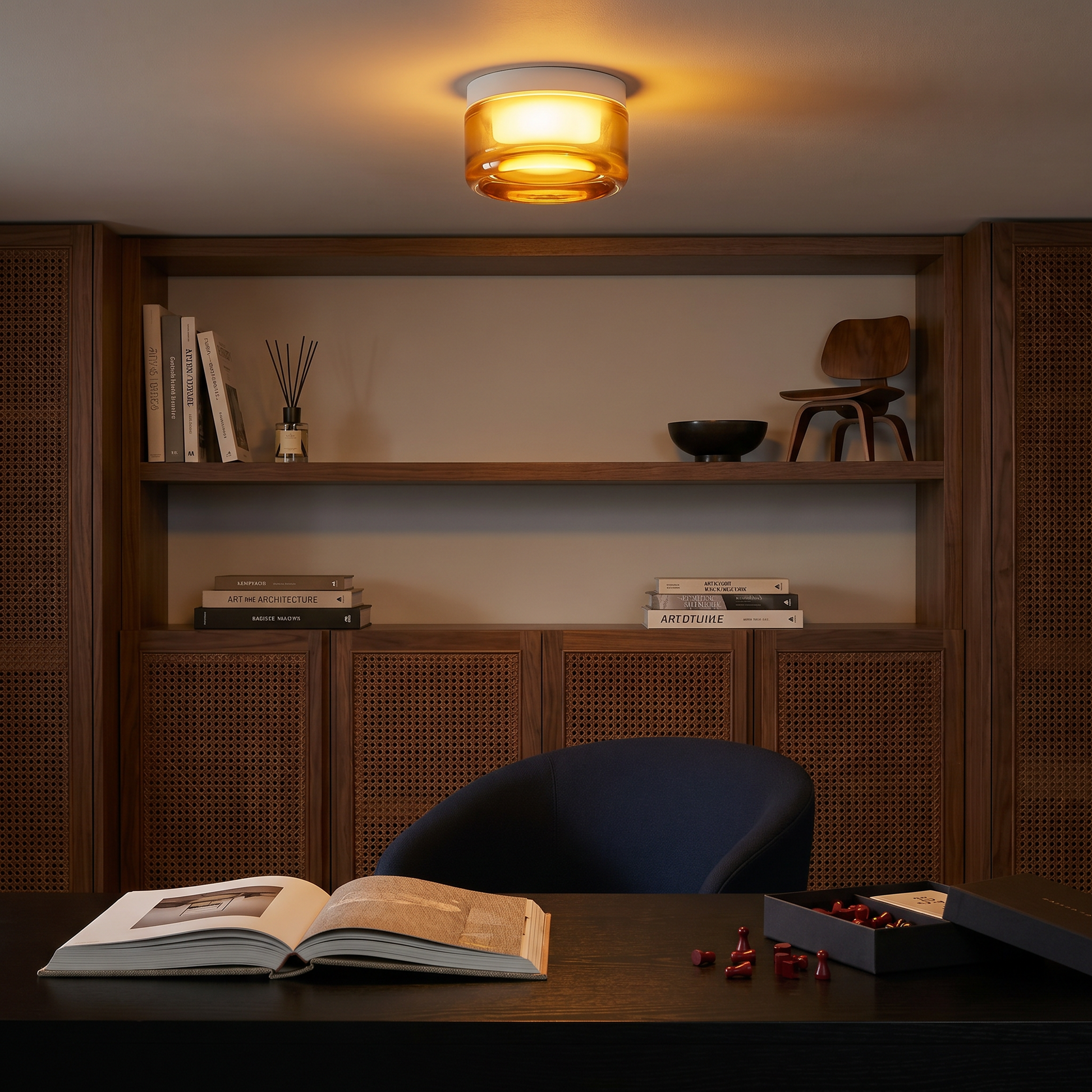 Three-quarter view of Acrylic Smoke Gray Concave three-color dimming 1-light wall sconce on study desk with warm light and brushed aluminum trim
