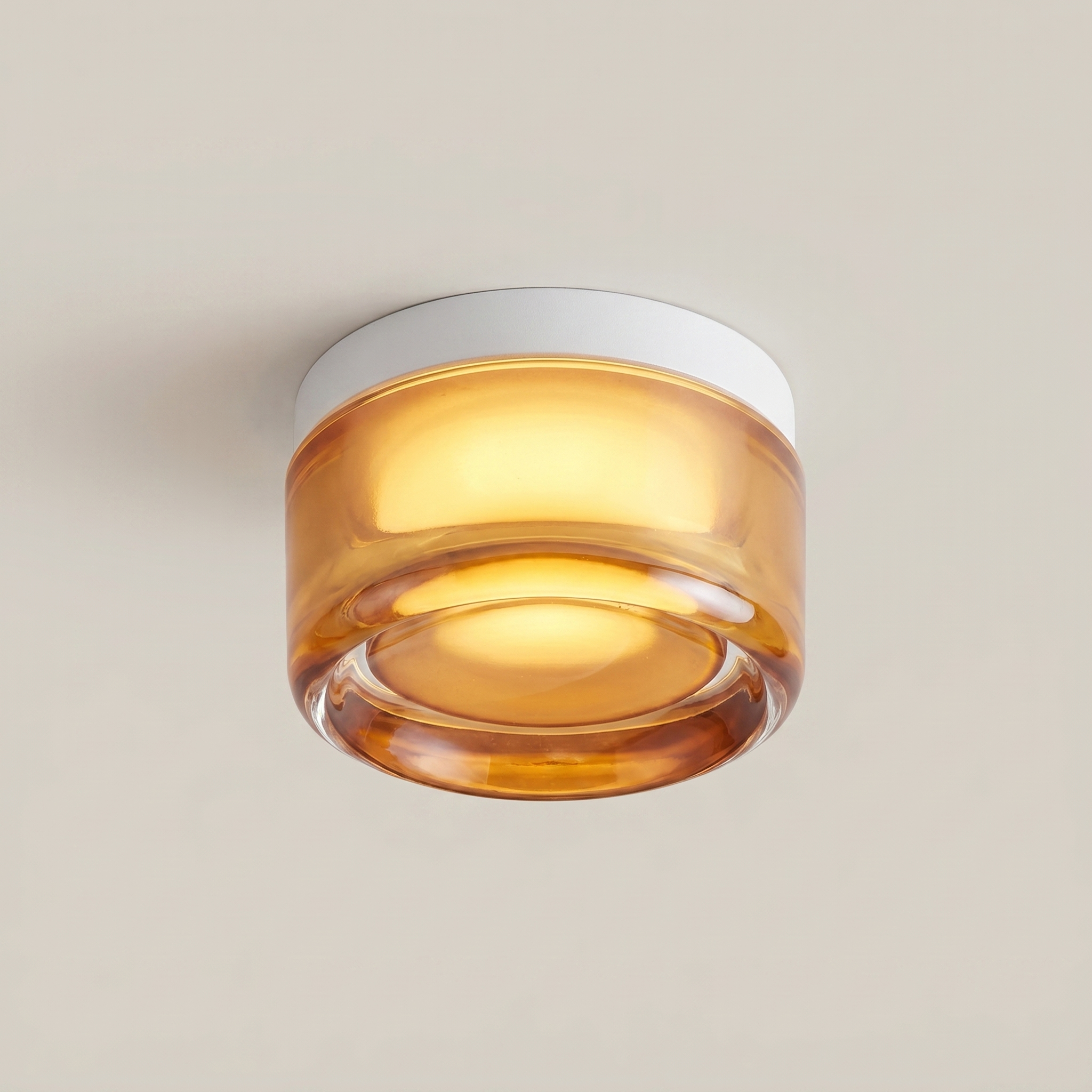 Low angle view of Acrylic Smoke Gray Concave three-color dimming 1-light wall sconce with brushed aluminum trim and warm glowing smoke gray acrylic