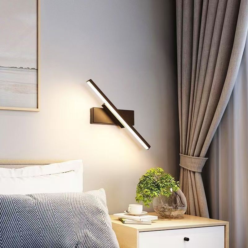 Detail shot of aluminum black bar adjustable LED wall sconce in 40cm length with LED light lit