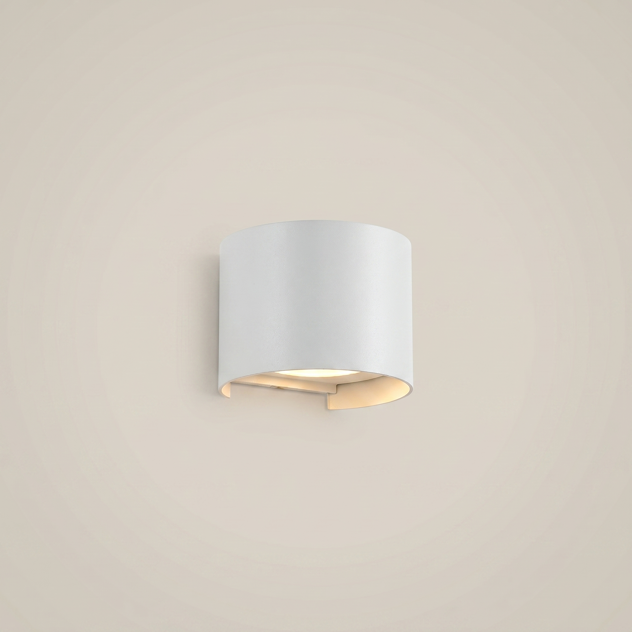 Low angle view of black aluminum square outdoor wall sconce lit on balcony at night with warm white adjustable lighting