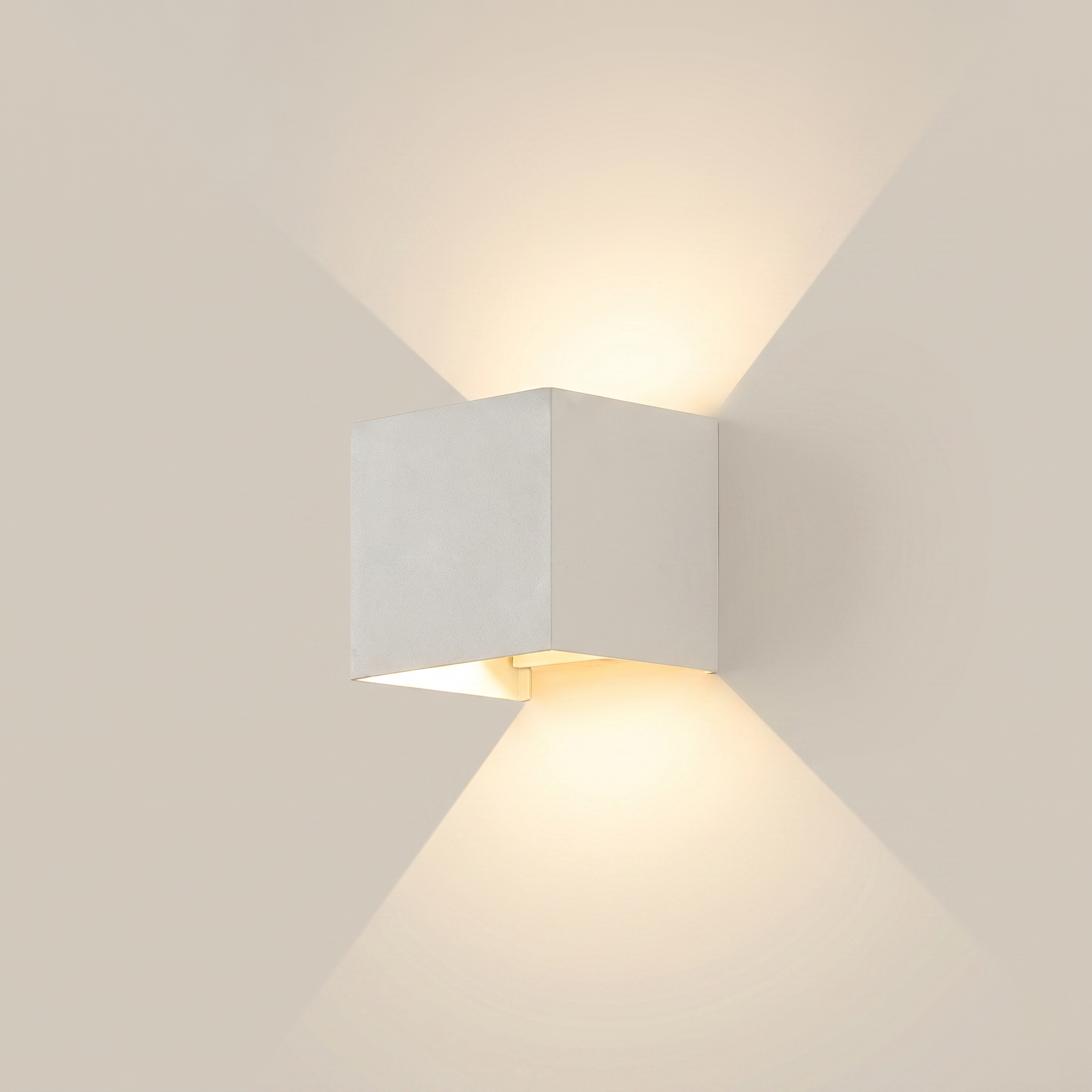 Side profile of black aluminum square outdoor wall sconce lit on exterior wall at night showing warm white dimmed light