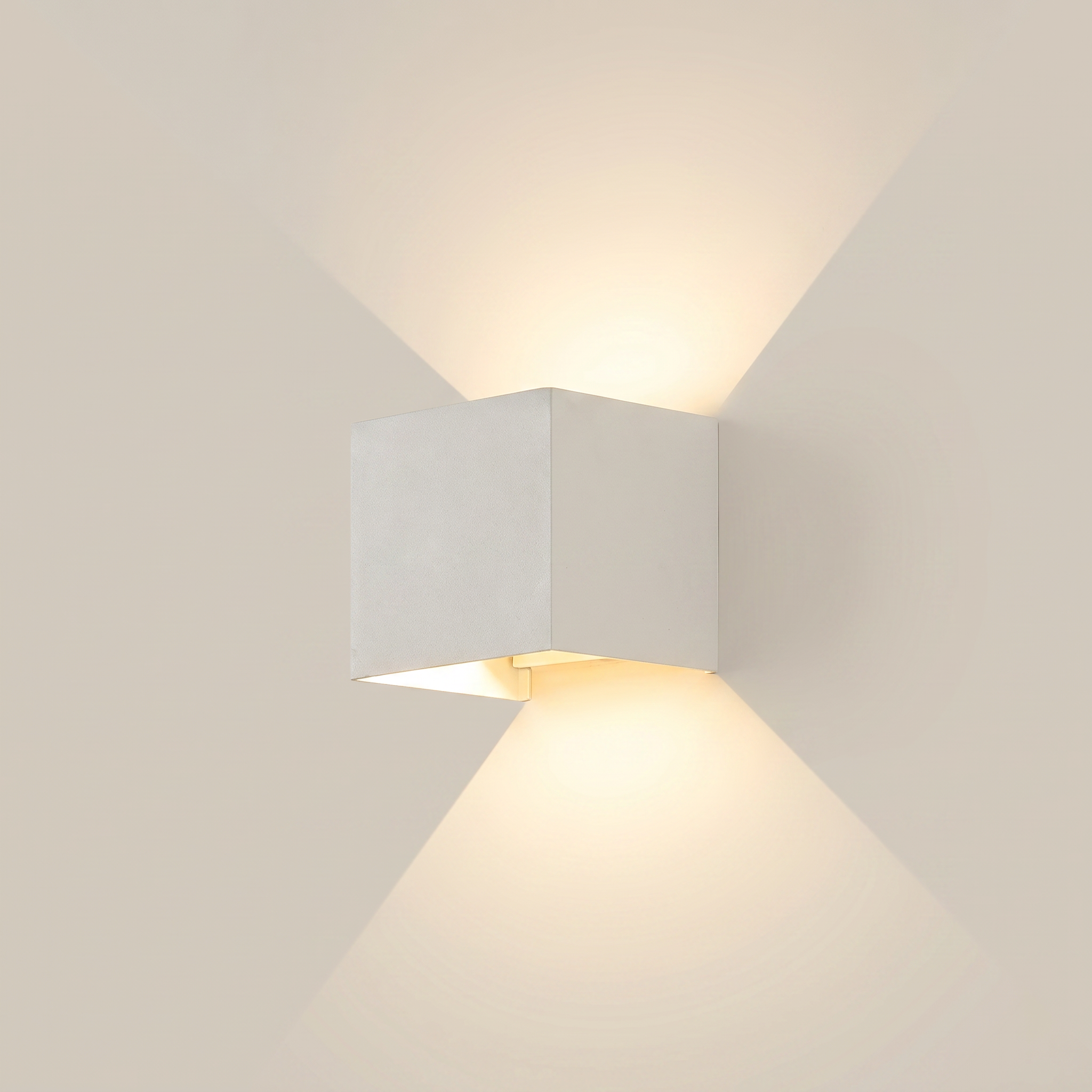 Side profile of black aluminum square outdoor wall sconce lit on exterior wall at night showing warm white dimmed light