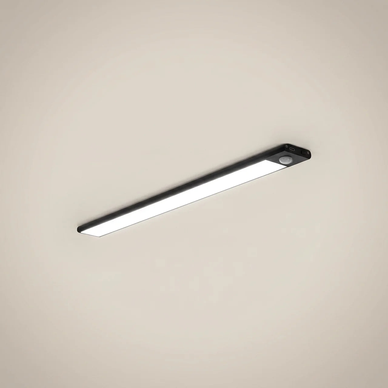 Close-up of aluminum silver linear motion sensor rechargeable under cabinet light lit showing slim profile and magnetic mount in silver finish