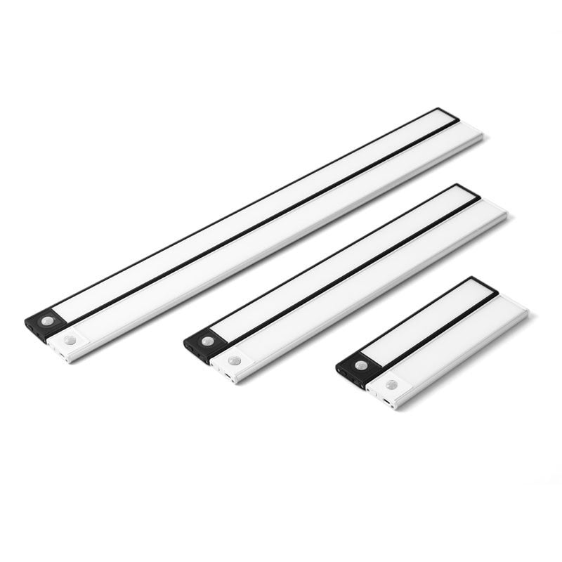 Top-down view of aluminum silver linear motion sensor rechargeable under cabinet light lit in silver finish on neutral studio background