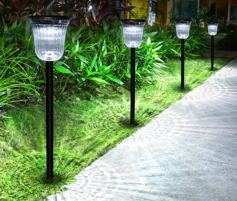 Three-quarter view of black ABS PC round solar panel dual color temperature LED garden path light showing ground insertion detail