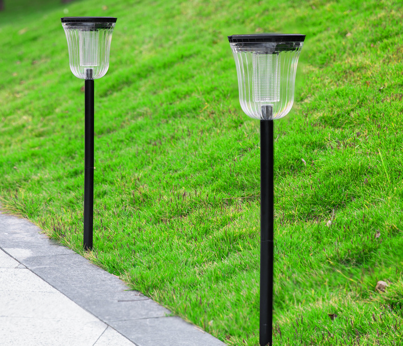 Top-down view of black ABS PC round solar panel dual color temperature LED garden path light showing solar panel texture