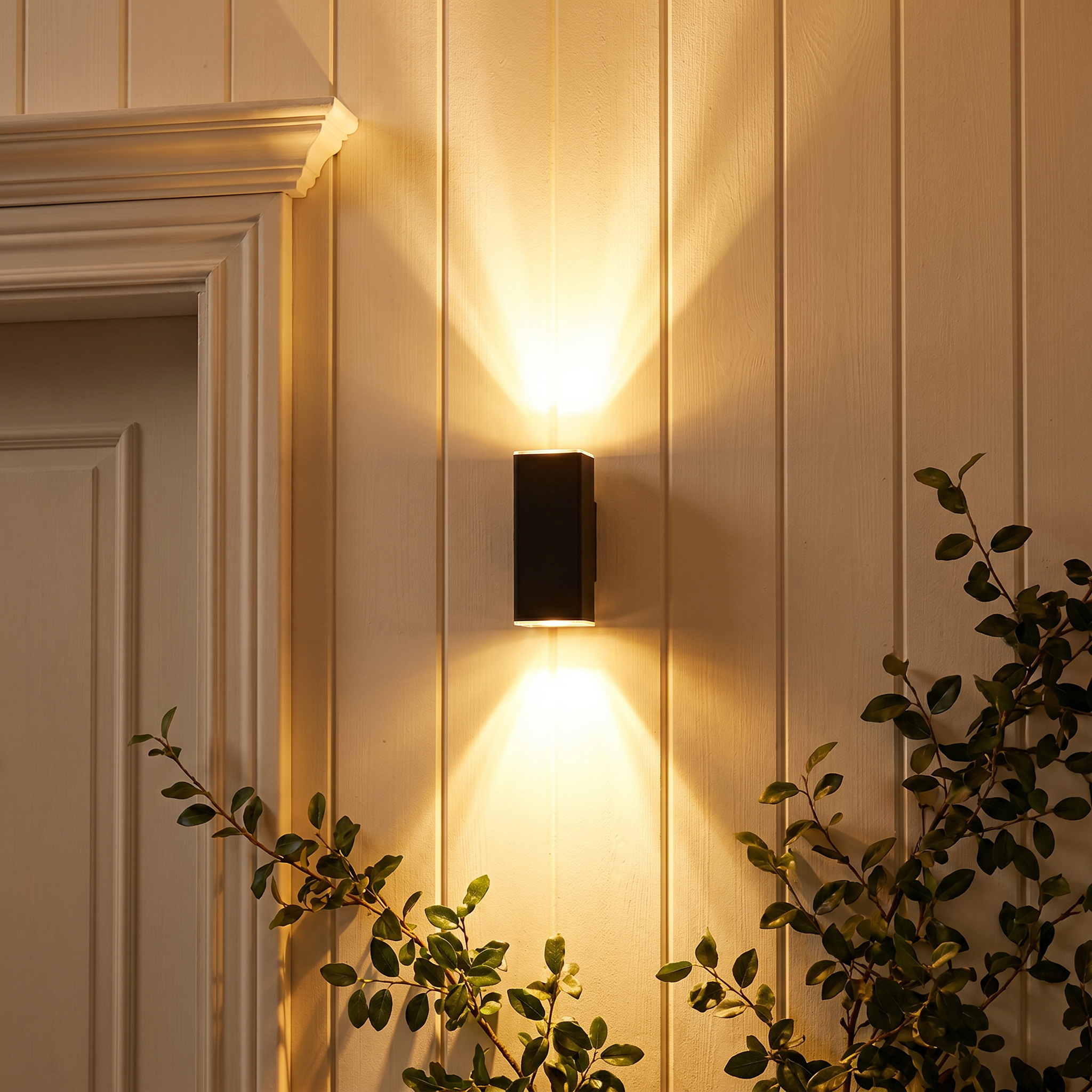 Black aluminum three-beam LED wall sconce shown front view lit in an outdoor corridor setting with IP65 waterproof rating