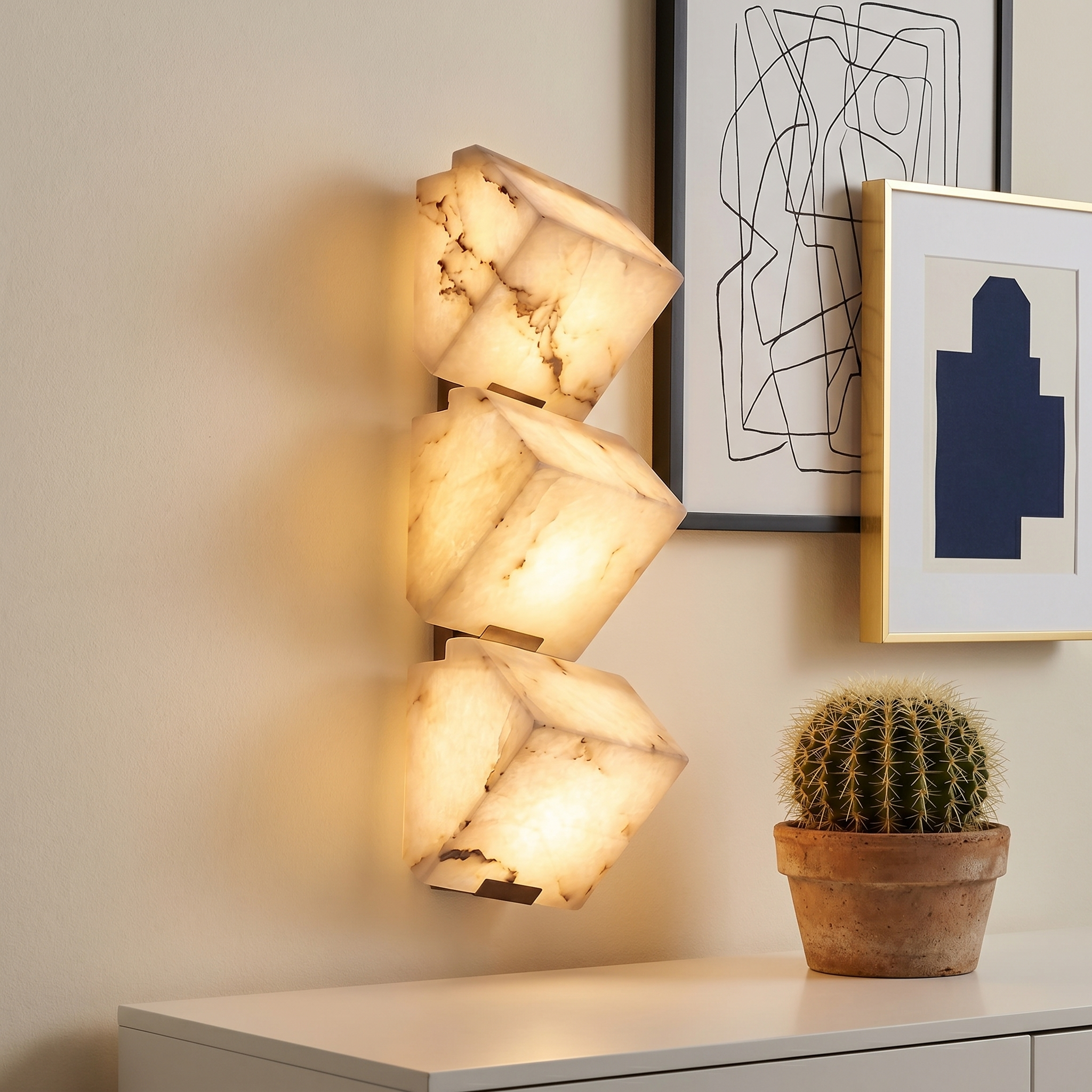 Black faux marble resin single-head LED wall sconce three-quarter angle lit in home office with black iron body and pull-chain switch visible