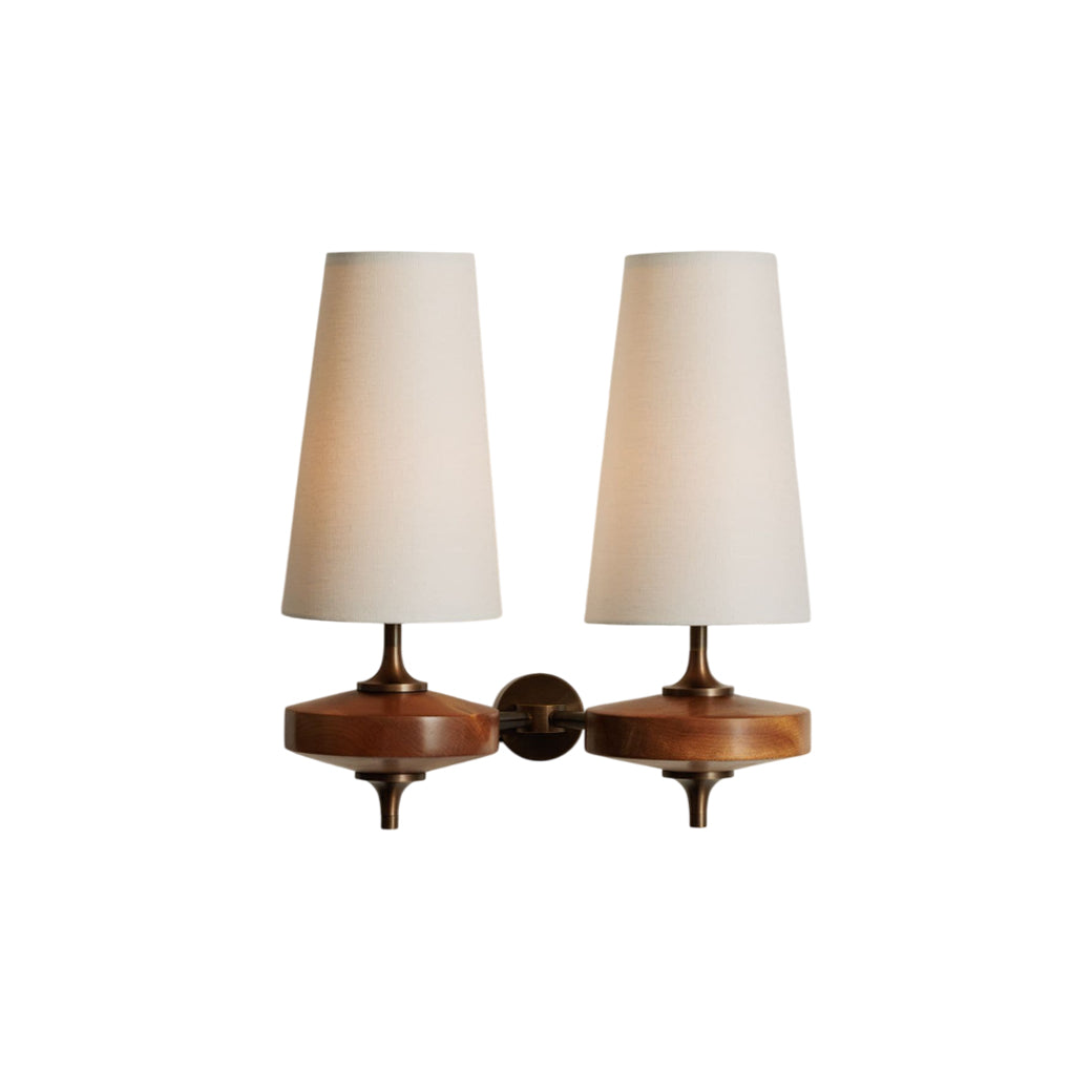 Eldoria Vintage Brass Wall Lamp with Antique Finish, two heads, white fabric shades, walnut wood base, and brass accents on a white background.