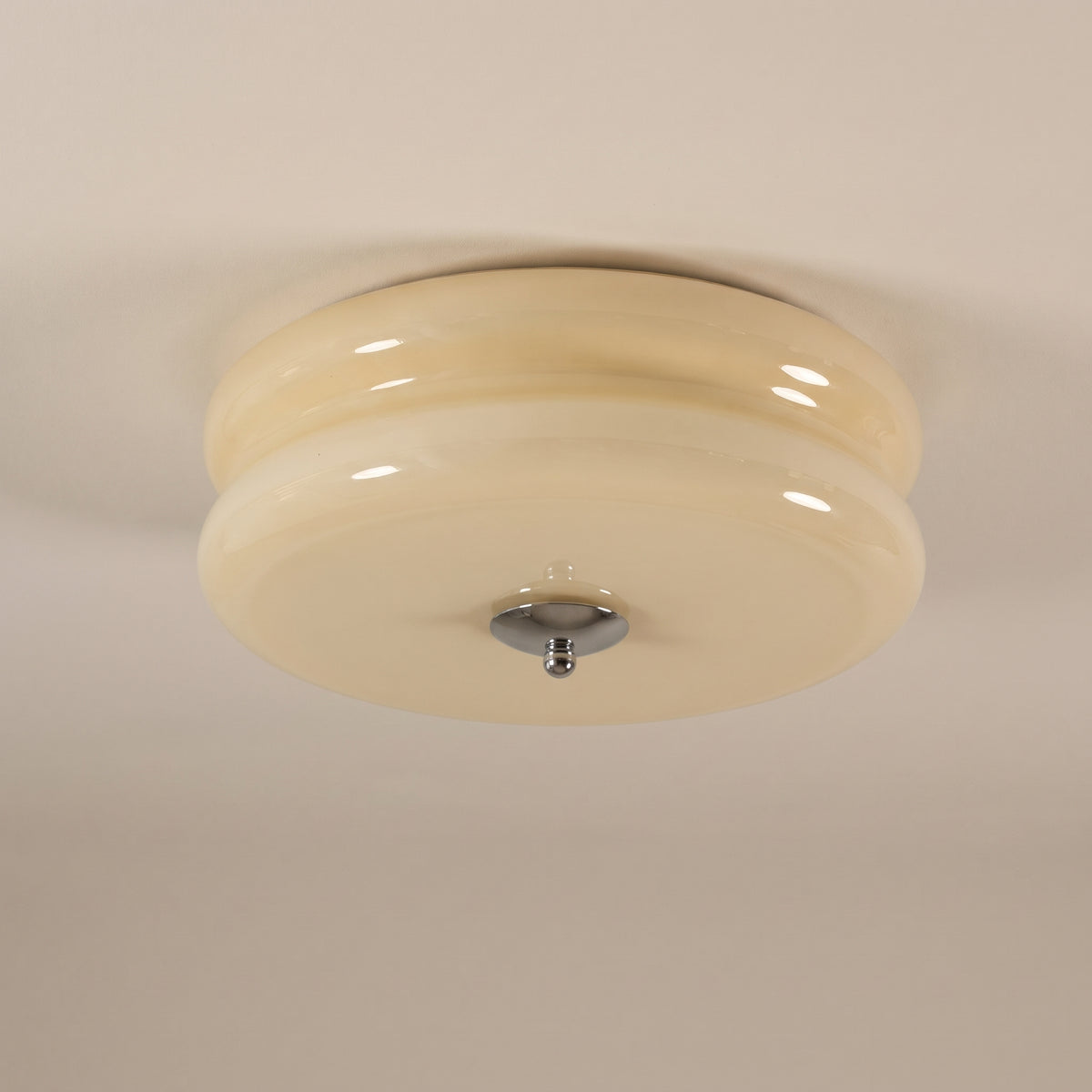 Époque glass pendant lamp with beige glass shade and chrome finish accent, isolated on a black background.