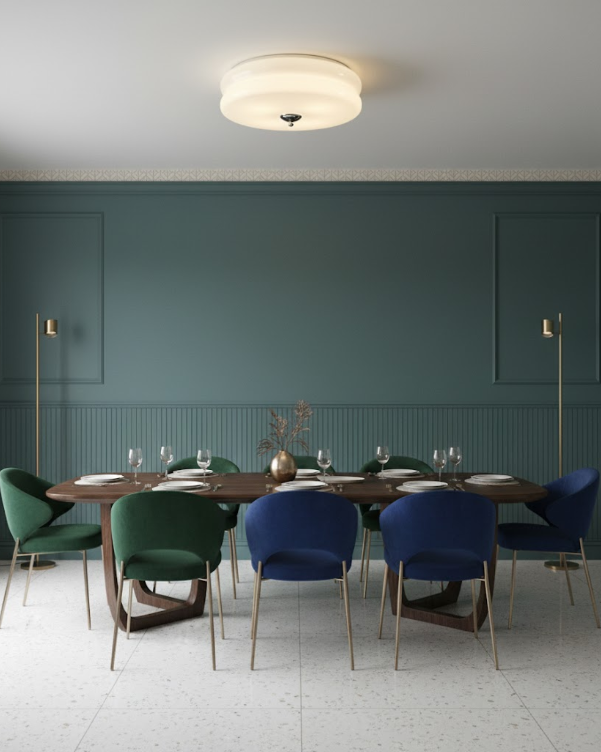 Époque glass pendant lamp with brass finish illuminating a modern dining room with a teal wall, a wooden dining table, and green and blue chairs.