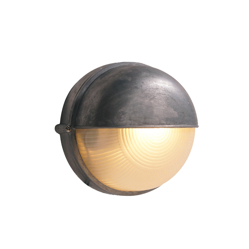 Fenwick vintage outdoor glass sconce wall lamp with round dark metal frame and ribbed clear glass, illuminated on a white background.