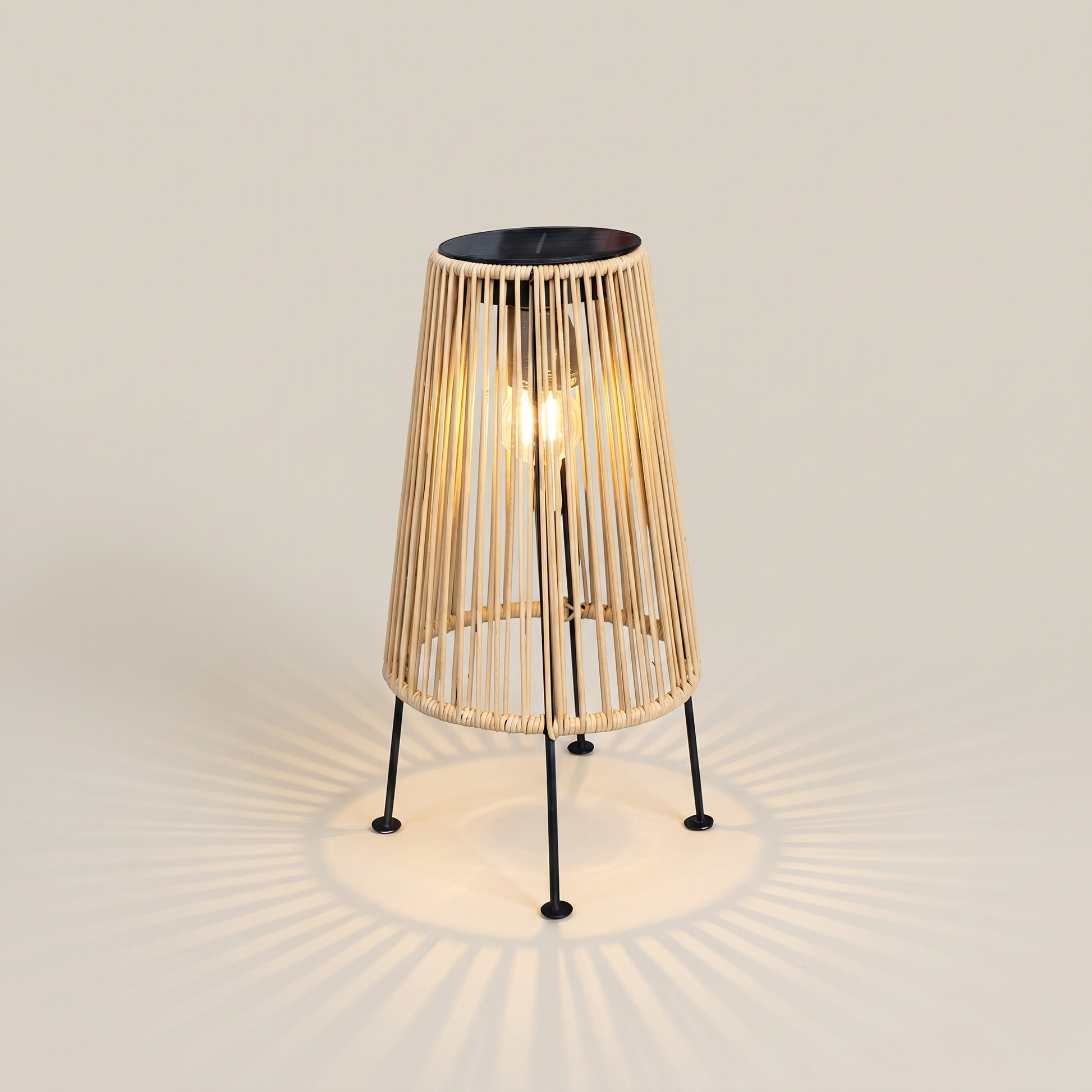 Handwoven rattan geometric solar LED tripod outdoor lantern shown front view in natural tan with warm light and tripod base visible