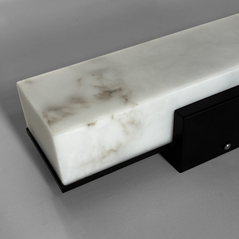 Ambient room view of imitation cloud stone rectangular waterproof LED outdoor wall sconce variant 5.1 inch wide by 31.5 inch high glowing with warm light