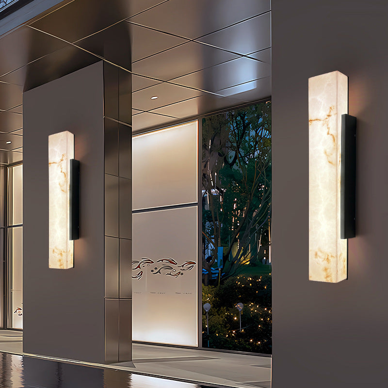 Three-quarter angle of imitation cloud stone rectangular waterproof LED outdoor wall sconce variant 5.1 inch wide by 19.7 inch high showing stone texture