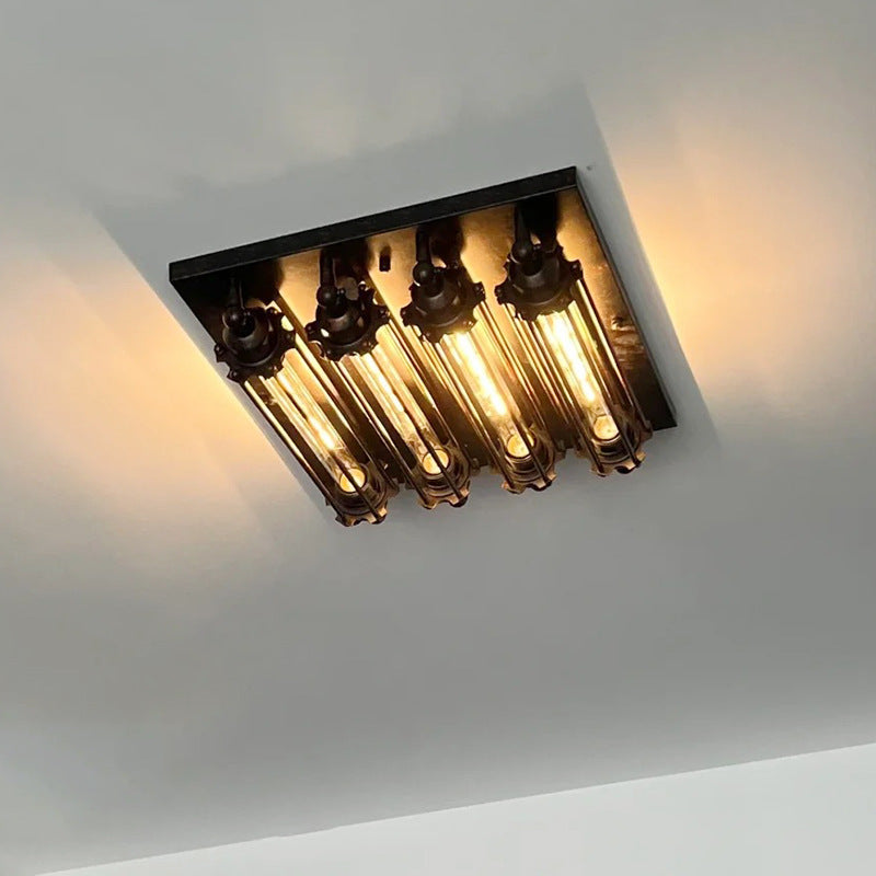 Side profile of iron multi-head LED wall sconce in black finish with warm light variant