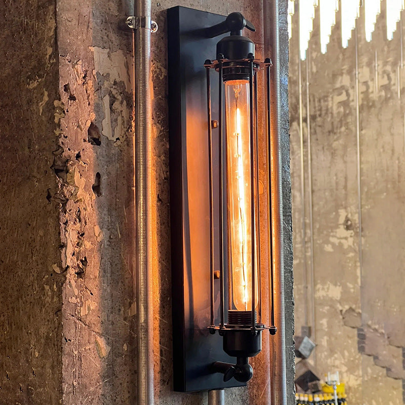 Iron multi-head LED wall sconce at three-quarter angle in black finish with warm glow variant