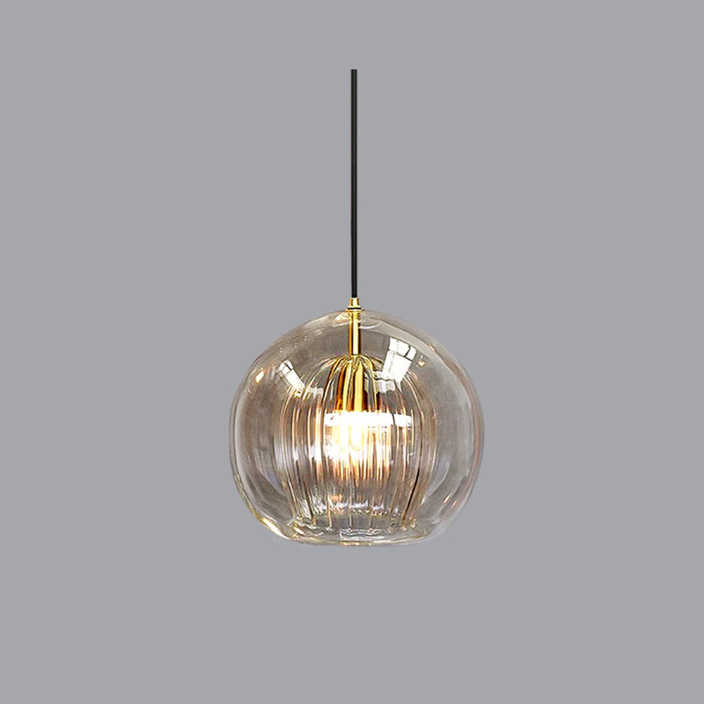 Close-up of a single Lustre Aura LED pendant light in clear glass, featuring a ribbed inner diffuser and emitting warm light, presented on a neutral gray background.