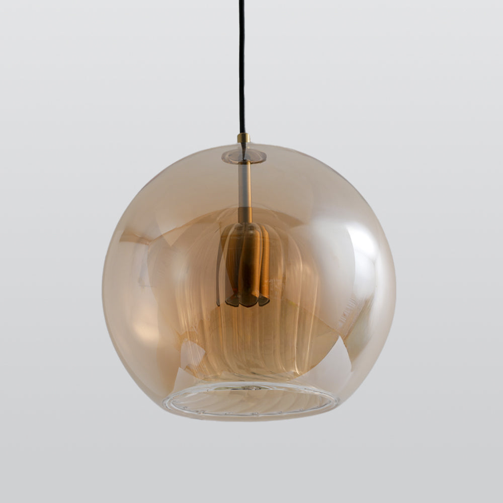 Full view of the Lustre Aura LED pendant light with an amber spherical glass shade, showing the bottom opening and ribbed inner glass, hanging.