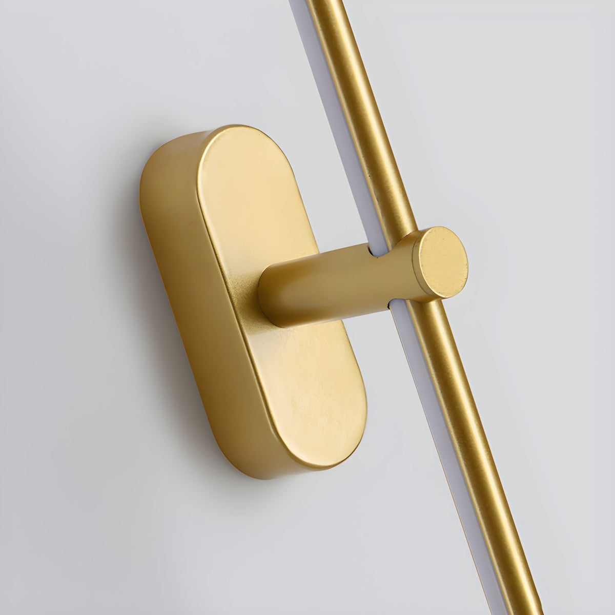 A close-up view of the gold Vestra Minimalist Linear Rechargeable Wall Lamp, highlighting its sleek metallic mounting base and the linear LED light bar. The image showcases the quality of the metal finish and the integrated LED strip.