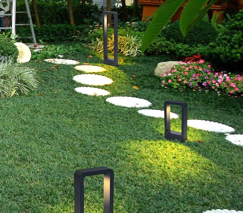 Front view of matte black aluminum rectangular IP65 10W LED outdoor lawn light base mount 23.6 inch height glowing cool white in villa garden
